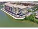 An aerial view features the condo complex, a restaurant, and a waterfront view with lake at 424 Luna Bella Ln # 330, New Smyrna Beach, FL 32168