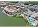 An aerial of the neighborhood shows multiple buildings, a lake, and a pool at 424 Luna Bella Ln # 330, New Smyrna Beach, FL 32168