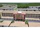 Bird's eye view of multiple buildings with tile roofs, a red car, and tropical trees at 424 Luna Bella Ln # 330, New Smyrna Beach, FL 32168