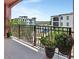 A tiled balcony overlooking the community has an ornamental metal rail and several potted plants at 424 Luna Bella Ln # 330, New Smyrna Beach, FL 32168