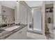 Bathroom with granite countertops, a decorative mirror and a modern shower at 424 Luna Bella Ln # 330, New Smyrna Beach, FL 32168