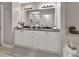 Elegant bathroom featuring double vanity with granite countertops and a soaking tub at 424 Luna Bella Ln # 330, New Smyrna Beach, FL 32168