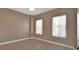 Neutral bedroom featuring two windows, light wood floors and fresh paint at 424 Luna Bella Ln # 330, New Smyrna Beach, FL 32168