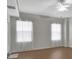 Bright bedroom with hardwood floors, ceiling fan, and large windows at 424 Luna Bella Ln # 330, New Smyrna Beach, FL 32168