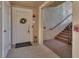 Inviting entryway featuring a white door, tiled floor, and staircase leading to upper levels at 424 Luna Bella Ln # 330, New Smyrna Beach, FL 32168