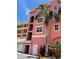 Exterior view of condos with a palm tree, stairs, and a view of the building's architecture at 424 Luna Bella Ln # 330, New Smyrna Beach, FL 32168