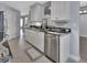 Updated kitchen with white cabinets, dark countertops, stainless steel appliances, and tiled flooring at 424 Luna Bella Ln # 330, New Smyrna Beach, FL 32168