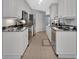 Well-equipped kitchen with white cabinetry, granite countertops, and stainless steel appliances at 424 Luna Bella Ln # 330, New Smyrna Beach, FL 32168