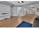 Open-concept living room with wood floors, built-in shelving, and a glimpse into the kitchen at 424 Luna Bella Ln # 330, New Smyrna Beach, FL 32168