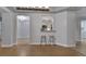 Open concept living area with view of the kitchen and hardwood floors at 424 Luna Bella Ln # 330, New Smyrna Beach, FL 32168