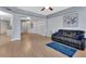 Bright living room with wood floors, gray walls, ceiling fan, and open access to kitchen at 424 Luna Bella Ln # 330, New Smyrna Beach, FL 32168