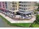 An aerial view shows Bistro 424 on the water with outdoor patio seating and umbrellas at 424 Luna Bella Ln # 330, New Smyrna Beach, FL 32168