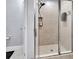 Modern shower with glass doors, tile surround, and a handheld shower head at 424 Luna Bella Ln # 330, New Smyrna Beach, FL 32168