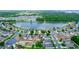 Aerial view of the community featuring a beautiful lake surrounded by homes, lush trees and well-maintained landscaping at 452 Casa Marina Pl, Sanford, FL 32771