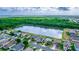 Aerial view of homes backing onto a scenic lake and lush green space, showcasing a serene neighborhood setting at 452 Casa Marina Pl, Sanford, FL 32771
