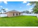 Expansive backyard featuring green lawn with the rear of a neutral colored house and a white fence surrounding the perimeter at 452 Casa Marina Pl, Sanford, FL 32771