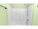 Shower room with white tiles and a shower head, walls are painted light green at 452 Casa Marina Pl, Sanford, FL 32771