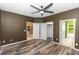 A bedroom featuring a ceiling fan, wood floors and access to the kitchen and bathroom at 452 Casa Marina Pl, Sanford, FL 32771