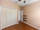 Bedroom with wood floors, built-in shelves, and a closet with ample storage space at 452 Casa Marina Pl, Sanford, FL 32771