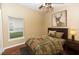 Staged bedroom with a bed, a bedside table, hardwood floor and natural light at 452 Casa Marina Pl, Sanford, FL 32771
