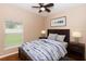 Cozy staged bedroom with hardwood floor, ceiling fan, a bed and two bedside tables at 452 Casa Marina Pl, Sanford, FL 32771