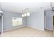 Bright dining room featuring tile floors, a modern light fixture, and a large window at 452 Casa Marina Pl, Sanford, FL 32771