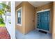 Covered entryway with blue door and welcome mat at 452 Casa Marina Pl, Sanford, FL 32771