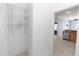 Hallway with a metal shelf, leading to the kitchen and living room area at 452 Casa Marina Pl, Sanford, FL 32771