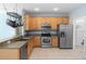 Bright kitchen featuring stainless steel appliances and light wood cabinets at 452 Casa Marina Pl, Sanford, FL 32771