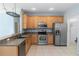 Bright kitchen featuring stainless steel appliances and light wood cabinets at 452 Casa Marina Pl, Sanford, FL 32771