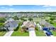 Street view of several homes with manicured lawns, palm trees, and a view of the community landscape at 452 Casa Marina Pl, Sanford, FL 32771