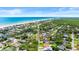 An aerial view of a charming coastal community with houses leading to the beach at 4638 Saxon Dr, New Smyrna Beach, FL 32169