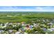 Aerial view showcasing a house with a pool surrounded by lush green foliage at 4638 Saxon Dr, New Smyrna Beach, FL 32169