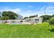 A lovely backyard with an inviting pool and well-maintained lawn on a sunny day at 4638 Saxon Dr, New Smyrna Beach, FL 32169