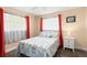 Cozy bedroom featuring a comfortable bed, bright window, and vibrant curtains creating a peaceful retreat at 4638 Saxon Dr, New Smyrna Beach, FL 32169