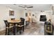 Open concept living room and dining room with tile floors, ceiling fan, neutral paint, and natural light at 4638 Saxon Dr, New Smyrna Beach, FL 32169