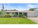 Charming single story home with a well-manicured lawn, beautiful landscaping, and a one-car garage at 4638 Saxon Dr, New Smyrna Beach, FL 32169