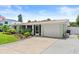 Well-maintained home with a white garage door, concrete driveway, and vibrant landscaping at 4638 Saxon Dr, New Smyrna Beach, FL 32169