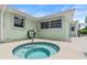 Inviting backyard hot tub with tile surround and lush, green landscaping at 4638 Saxon Dr, New Smyrna Beach, FL 32169