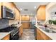 Updated kitchen featuring stainless steel appliances, granite counters, and attractive wooden cabinetry at 4638 Saxon Dr, New Smyrna Beach, FL 32169