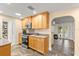 Bright kitchen featuring stainless steel appliances, and light wood cabinets, open to living area at 4638 Saxon Dr, New Smyrna Beach, FL 32169