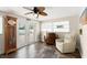 Comfortable living room features a clock, tile floors, a ceiling fan and access to the pool outside at 4638 Saxon Dr, New Smyrna Beach, FL 32169