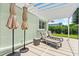 Relaxing patio area with lounge chairs, umbrellas, and privacy landscaping at 4638 Saxon Dr, New Smyrna Beach, FL 32169