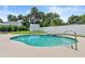Sparkling pool area with manicured lawn, white fence, and a storage shed in the backyard at 4638 Saxon Dr, New Smyrna Beach, FL 32169