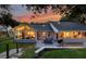 Back exterior of home featuring a sun room with lots of windows and a patio with outdoor seating at 4791 S Peninsula Dr, Ponce Inlet, FL 32127