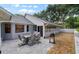 Comfortable backyard patio with an outdoor dining set and room for entertaining at 4791 S Peninsula Dr, Ponce Inlet, FL 32127