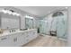 Sleek bathroom features a double vanity, a spacious shower with rain head, and a pebble floor at 4791 S Peninsula Dr, Ponce Inlet, FL 32127
