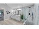 Light-filled bathroom boasts double vanity, large walk-in shower, and tasteful decor at 4791 S Peninsula Dr, Ponce Inlet, FL 32127