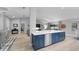 Open floor plan with kitchen island, blue cabinets, and views to living area at 4791 S Peninsula Dr, Ponce Inlet, FL 32127