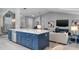 Modern kitchen island features blue cabinets, white countertop, and gold hardware at 4791 S Peninsula Dr, Ponce Inlet, FL 32127